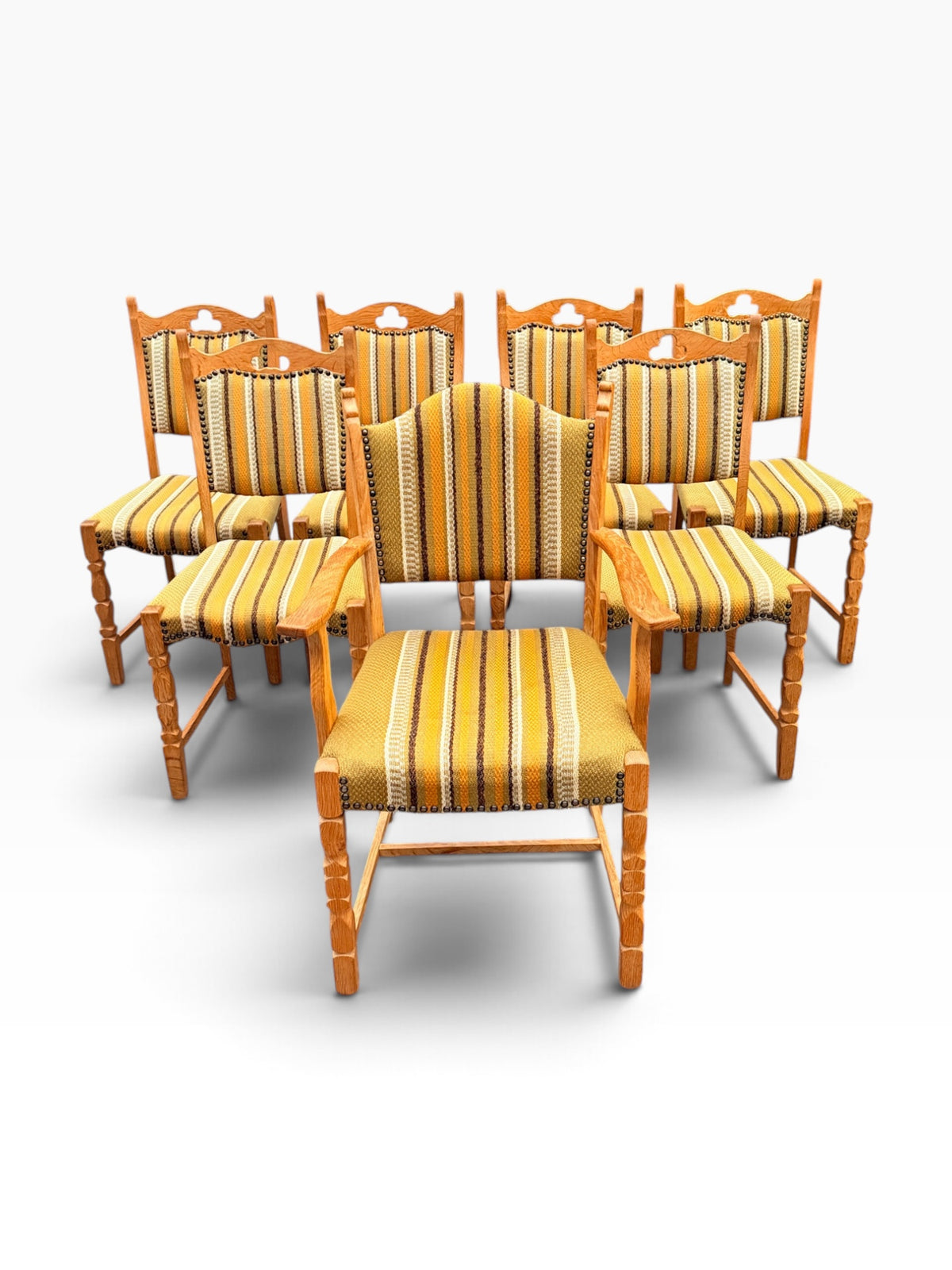 Seven Danish oak dining chairs, grouped front view