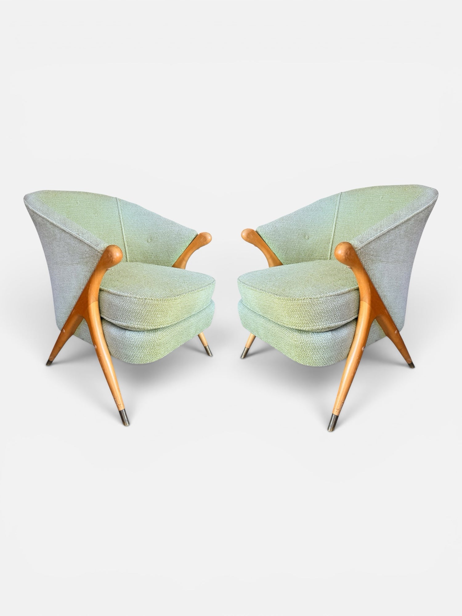 Pair of Italian mid-century lounge chairs in mint green boucle with maple frames — front three-quarter view