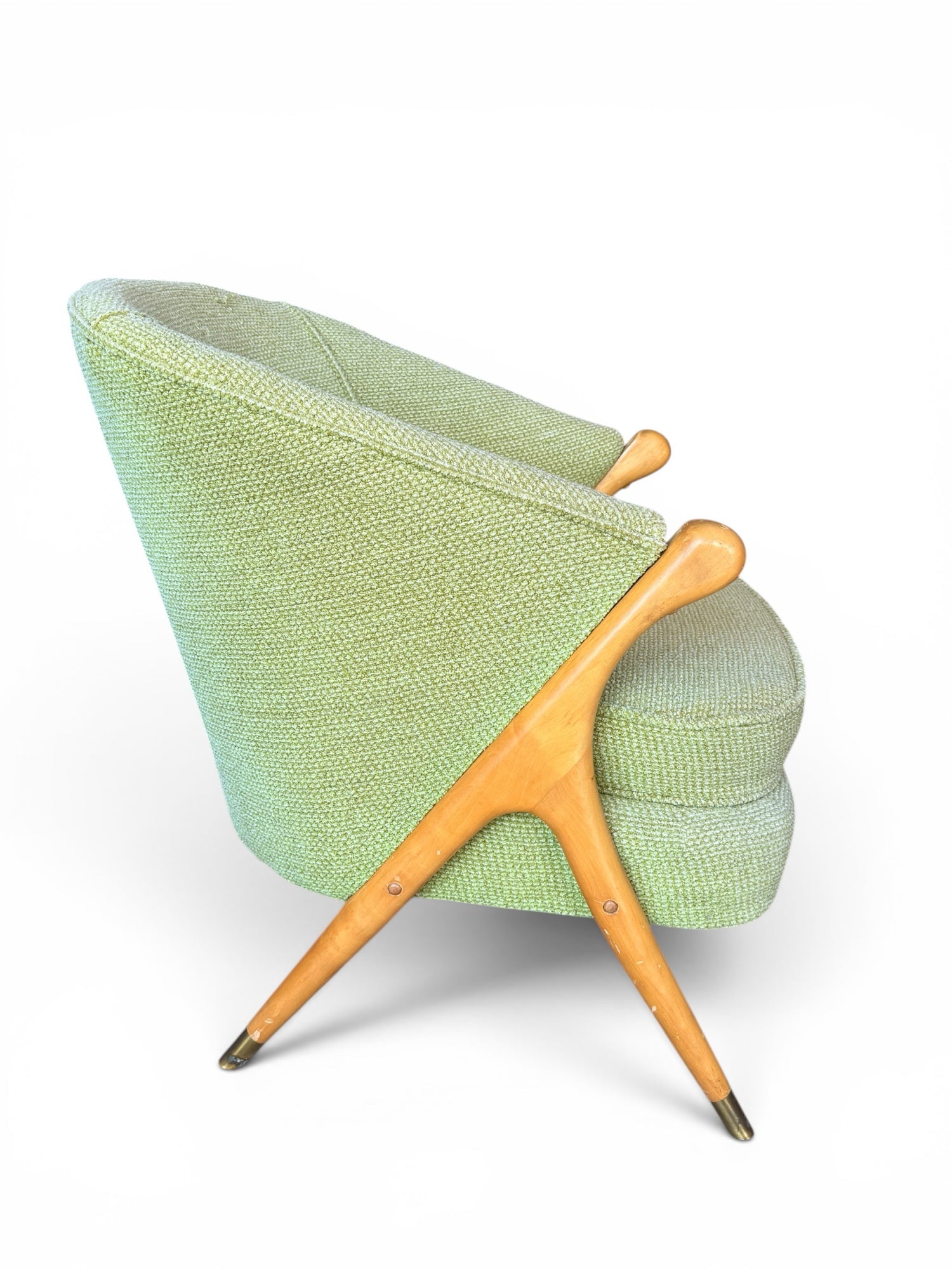 Italian lounge chair — side profile showing sculptural maple arm and brass-tipped legs