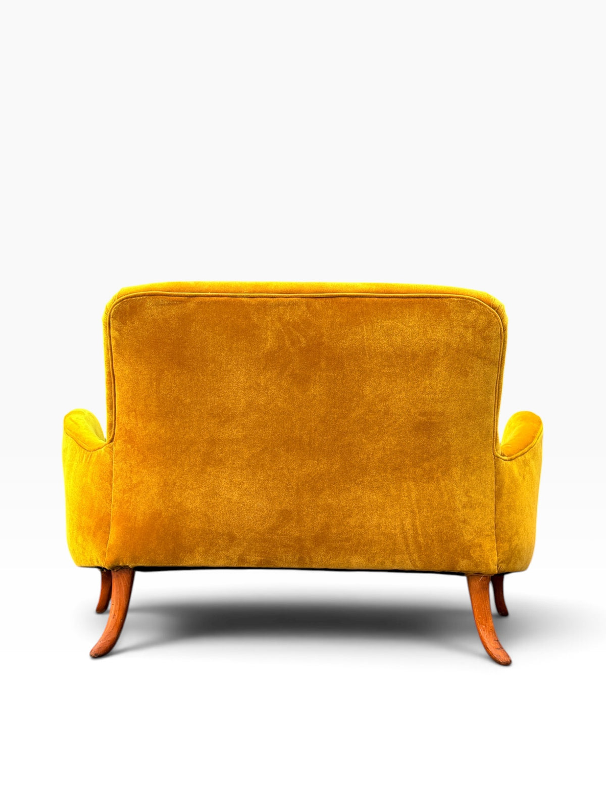 Rear view of the fully upholstered saffron velvet loveseat