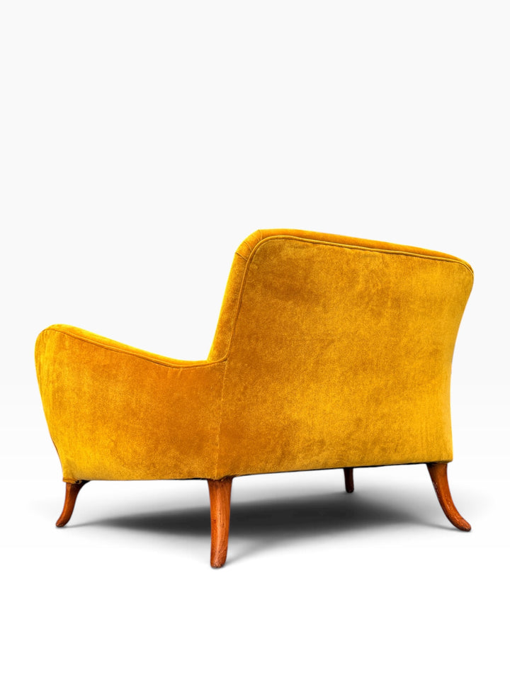 Rear detail of the crest rail and back upholstery seams