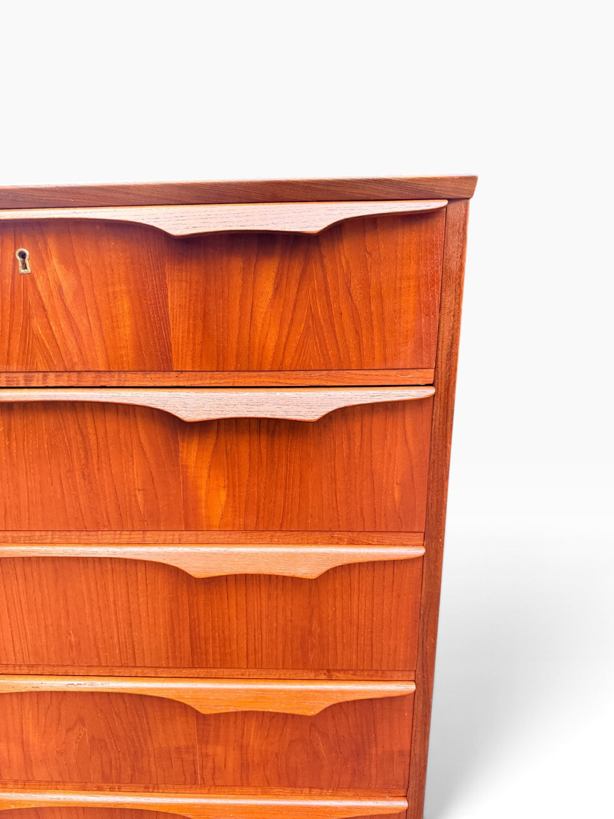 Sculpted teak drawer pulls and keyhole close-up