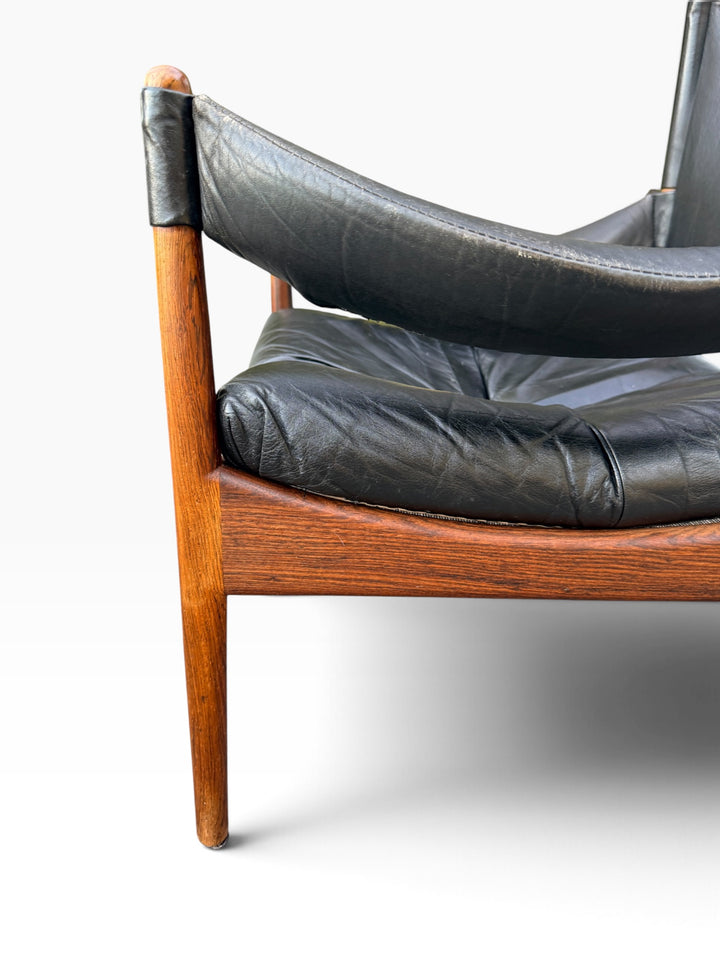 Close-up of rosewood frame and leather cushion