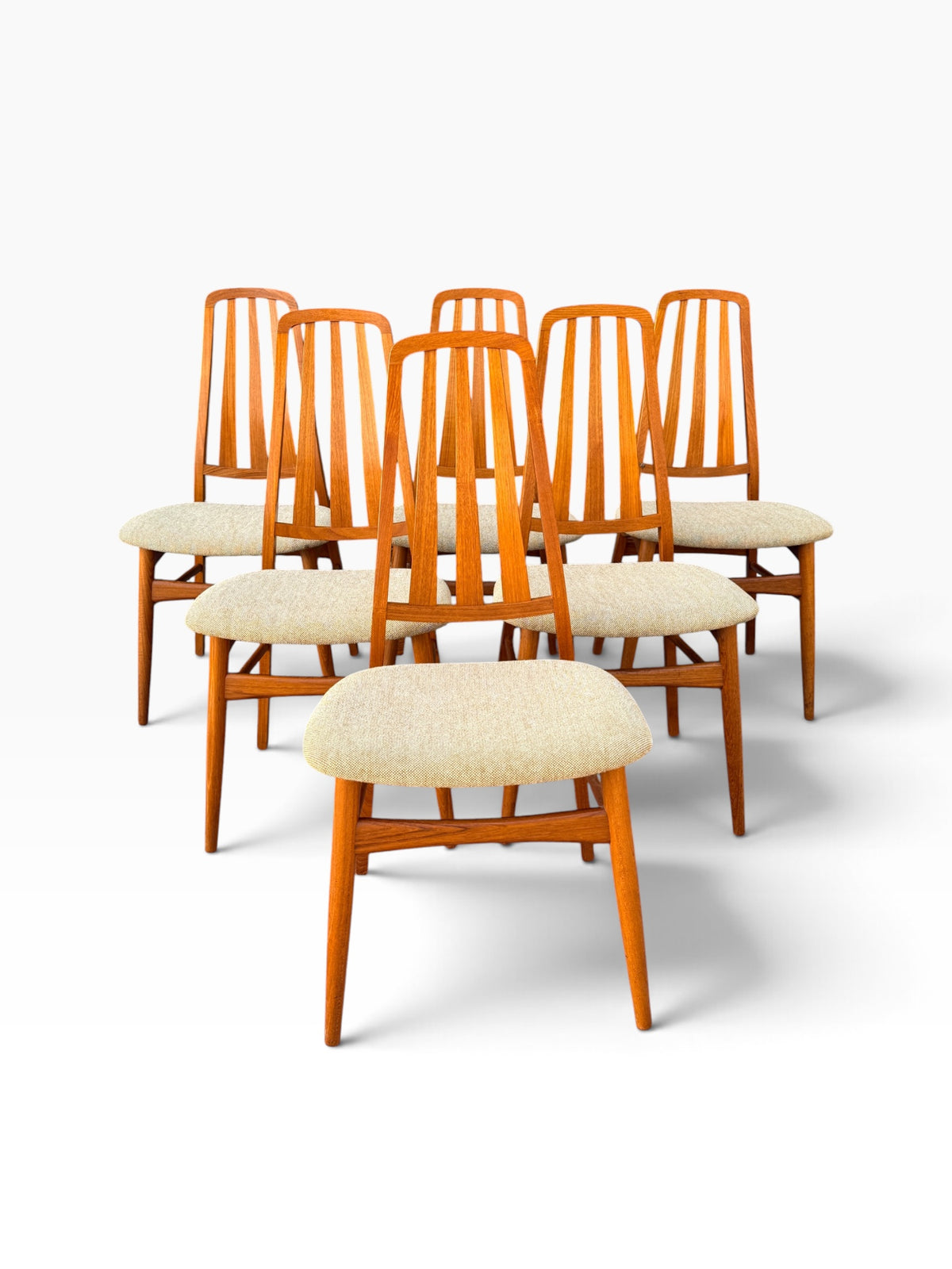 Six Danish modern teak dining chairs grouped together