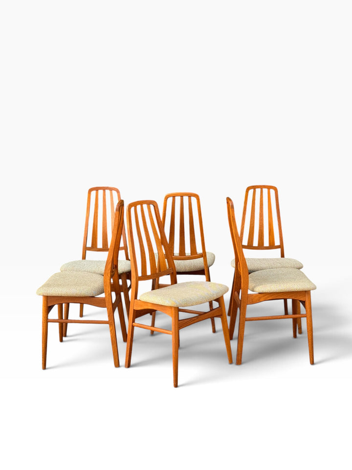 Group of Danish teak dining chairs from the side