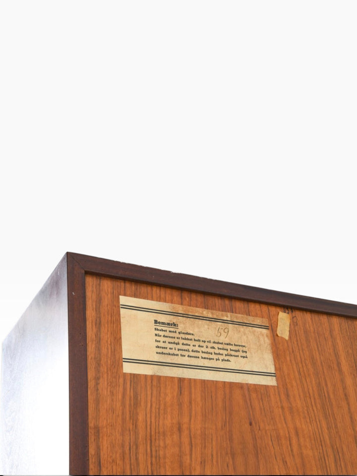 Original Danish instruction label on the back of the cabinet
