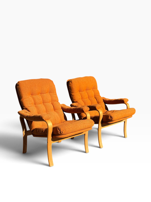 Pair of mid-century bentwood lounge chairs in new burnt orange upholstery, three-quarter view