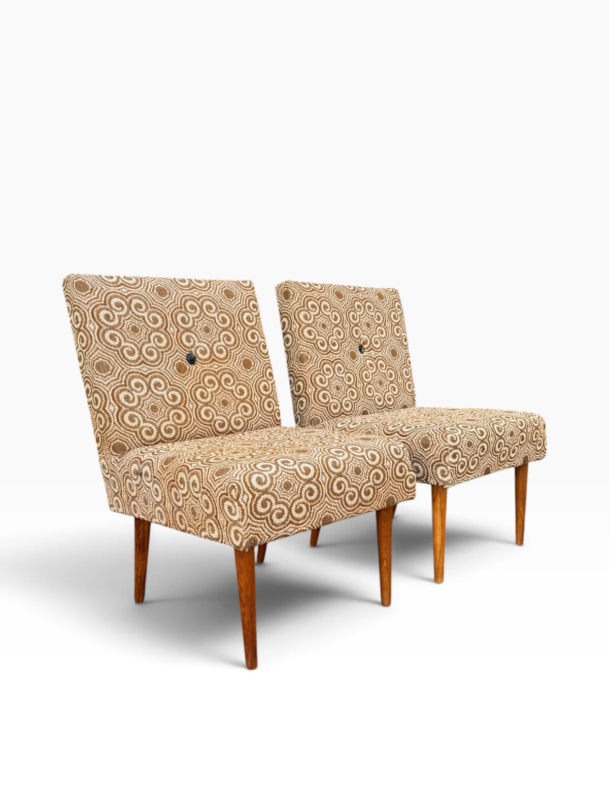 Pair of retro slipper chairs on tapered wooden legs, three-quarter view
