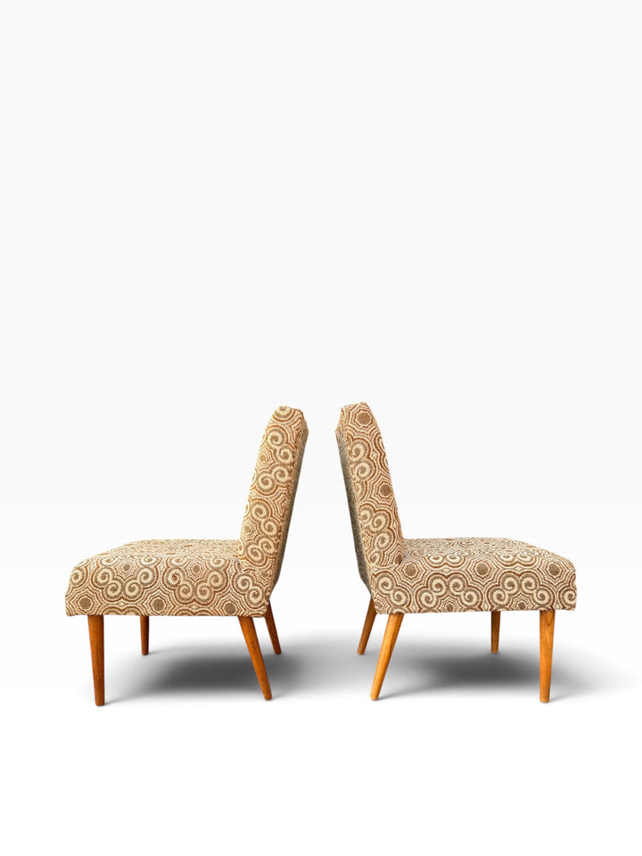 Pair of slipper chairs in side profile