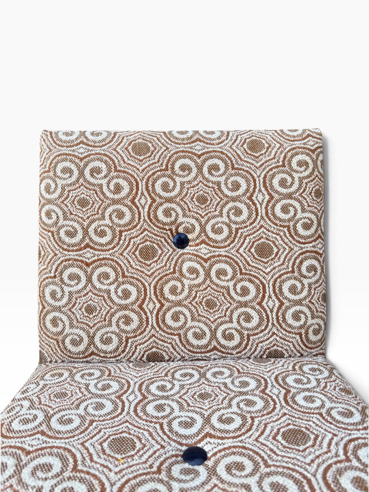 Close-up of original swirl medallion fabric with button tuft