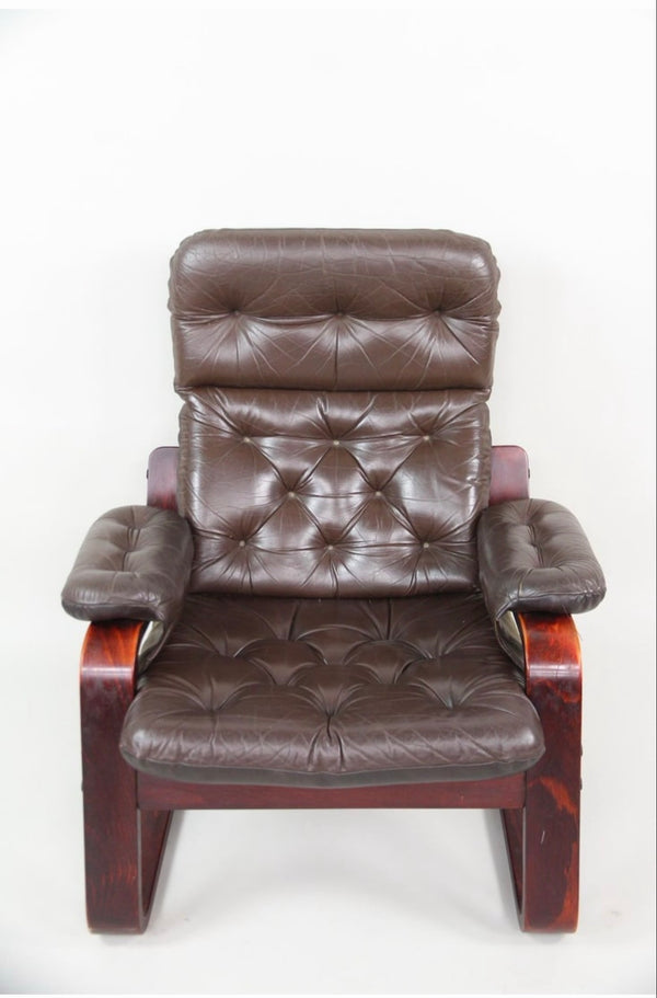 Scandinavian modern cantilevered tufted brown leather lounge chair, front view