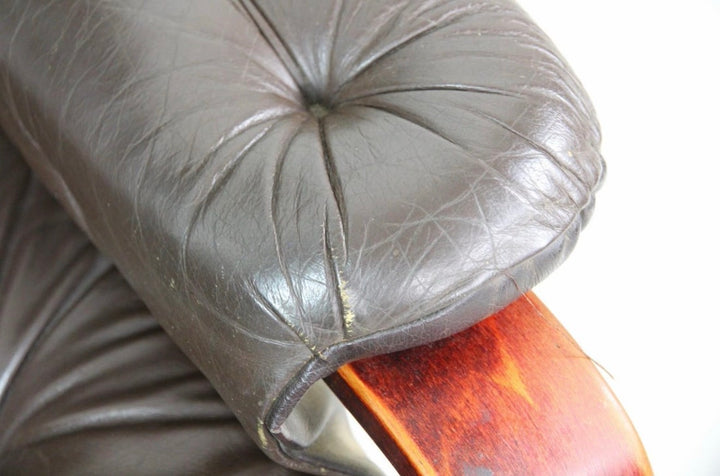 Close detail of a leather arm pad showing patina and seam wear