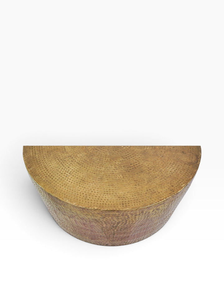 Elevated view of the tapered hammered brass drum body of the Izmir coffee table