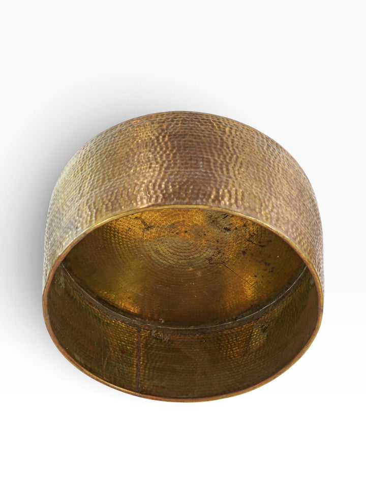 Underside of the hammered brass drum coffee table showing the open interior