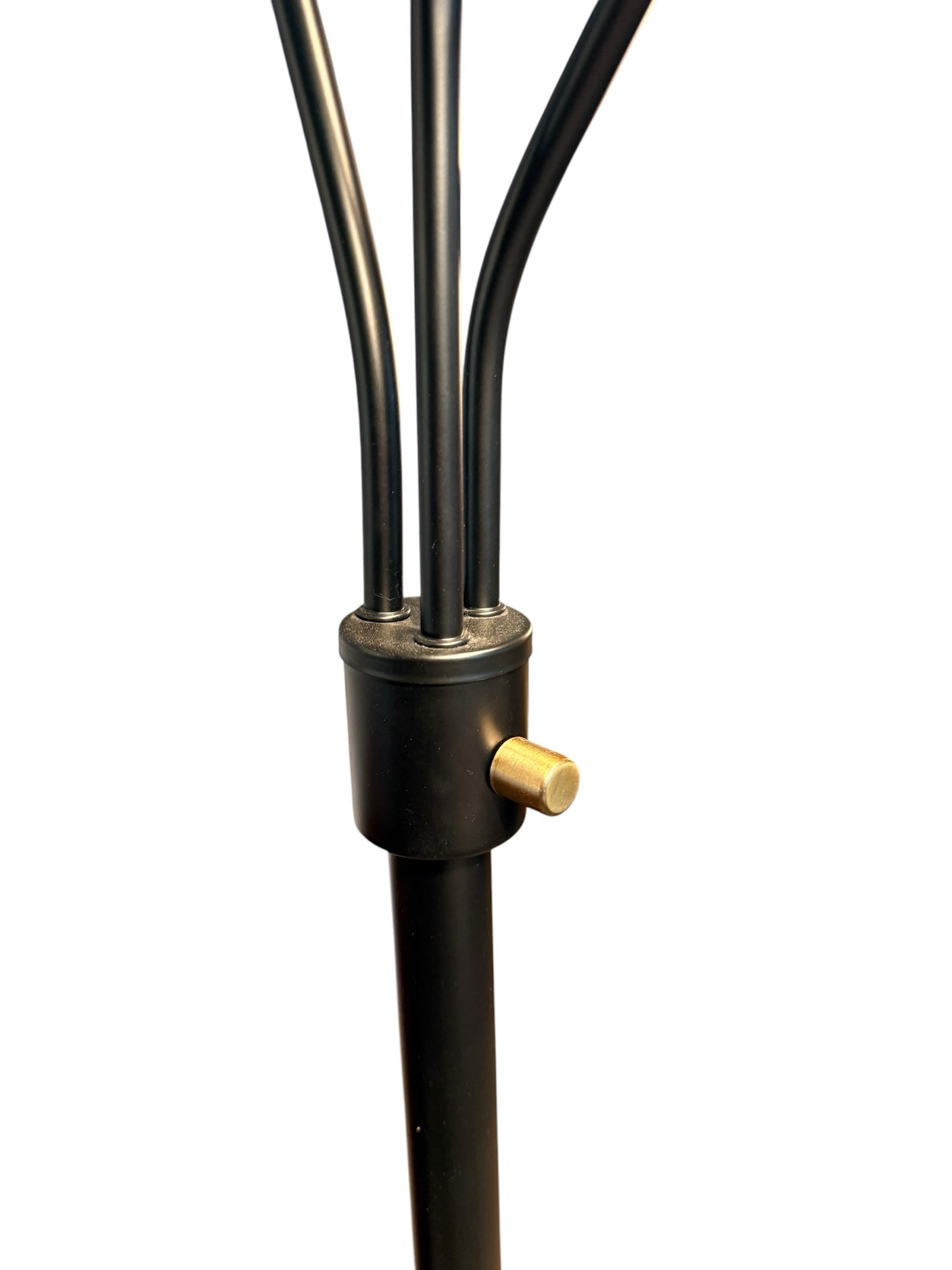 Modern three-arm floor lamp — brass hub and arm junction detail