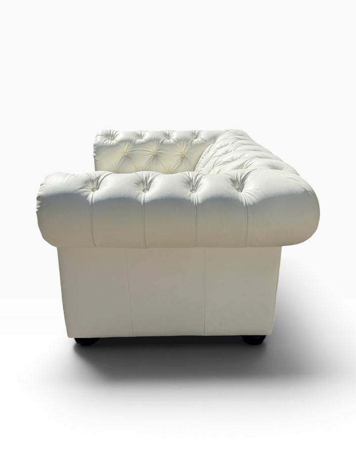 Side profile of white leather Chesterfield club chair